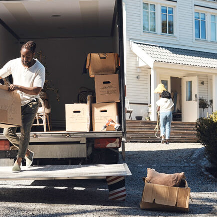 Photo: man unloading boxes from a moving truck