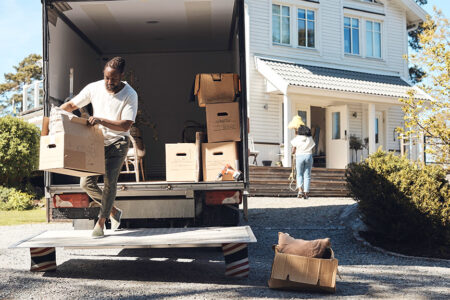 Photo: man unloading boxes from a moving truck
