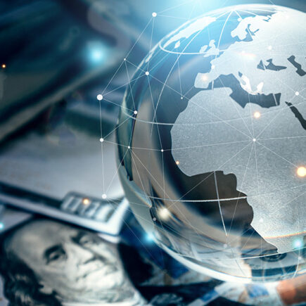 Photo: Crystal globe on many currency.