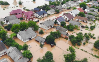 Decorative image: Aerial view river that flooded the city and houses. Flooded houses in the water.