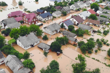Decorative image: Aerial view river that flooded the city and houses. Flooded houses in the water.