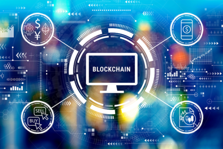 Decorative image: blockchain with spokes including cryptocurrency, mobile $, buy/sell icons. Cryptocurrency fintech theme with big city lights at night.