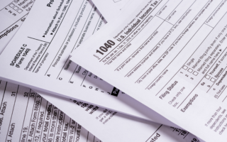 Photo: U.S. individual income tax forms 1040 and schedule c.