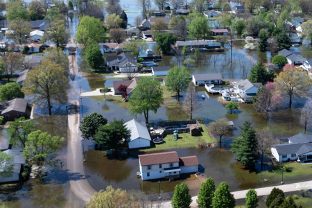 An aerial view shows floodwater surrounding homes on April 07, 2025 in East Prairie, Missouri. Thunderstorms, heavy rains, high winds and tornadoes have plagued the region for the past several days, causing widespread damage before moving east. (Photo by Scott Olson/Getty Images)
