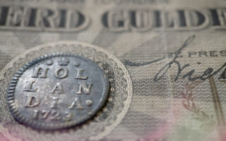 Photo: Old Dutch coins from the province of Holland with ancient Dutch banknotes.