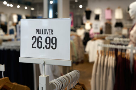 Price tag on a clothes rack with the inscription Pullover, Sweater 26.99