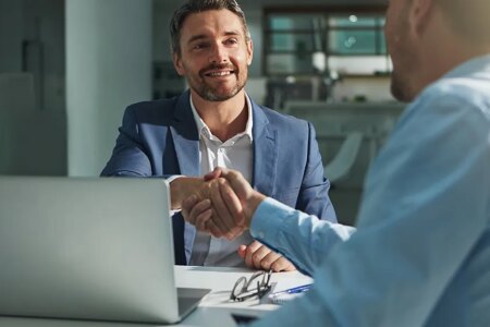 Business people, handshake and interview success or recruitment, employment and hiring in office. Corporate, men and executive shaking hands with new employee or collaboration on deal or partnership.