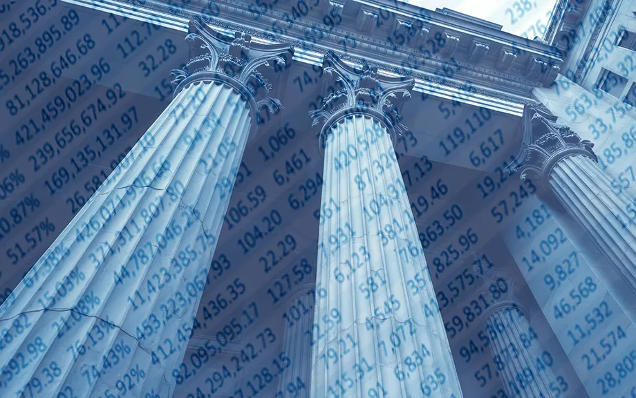 Classic bank building with columns overlaid with balance sheet numbers.