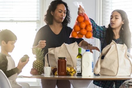 Mother and children unloading groceries
