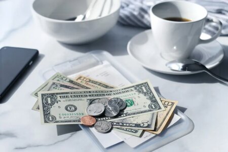 Image of a cafe receipt with U.S. money on top to pay the bill.