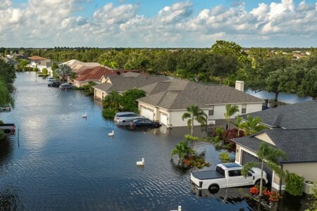 Hurricane Debby tropical rainstorm flooded residential homes and cars in suburban community in Sarasota, Florida. Aftermath of natural disaster.