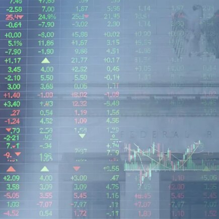 Decorative image of stock price board superimposed on the Federal Reserve building in Washington, D.C.