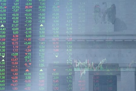 Decorative image of stock price board superimposed on the Federal Reserve building in Washington, D.C.