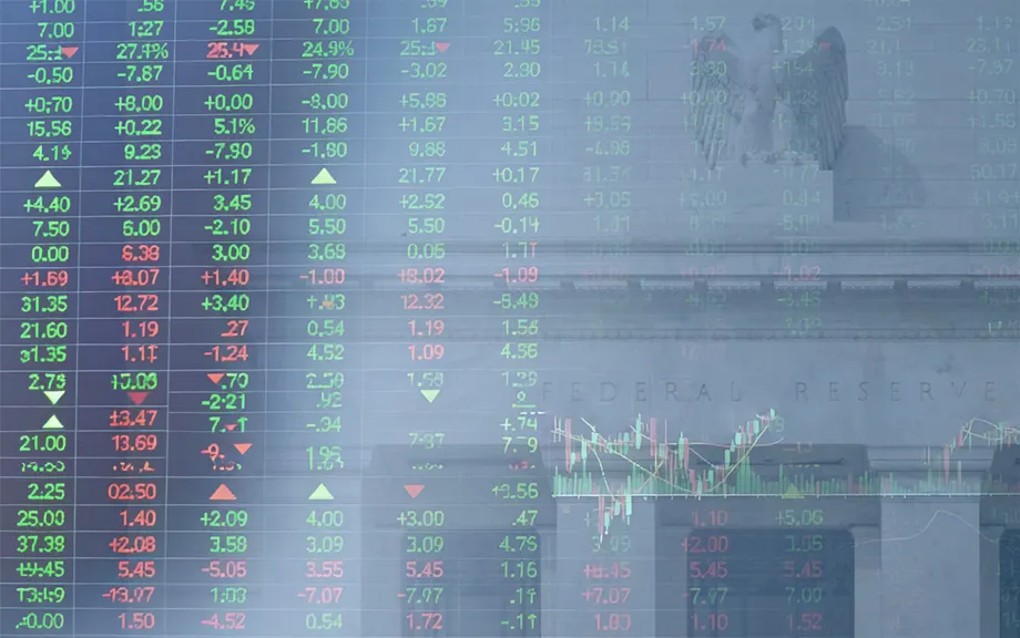 Decorative image of stock price board superimposed on the Federal Reserve building in Washington, D.C.